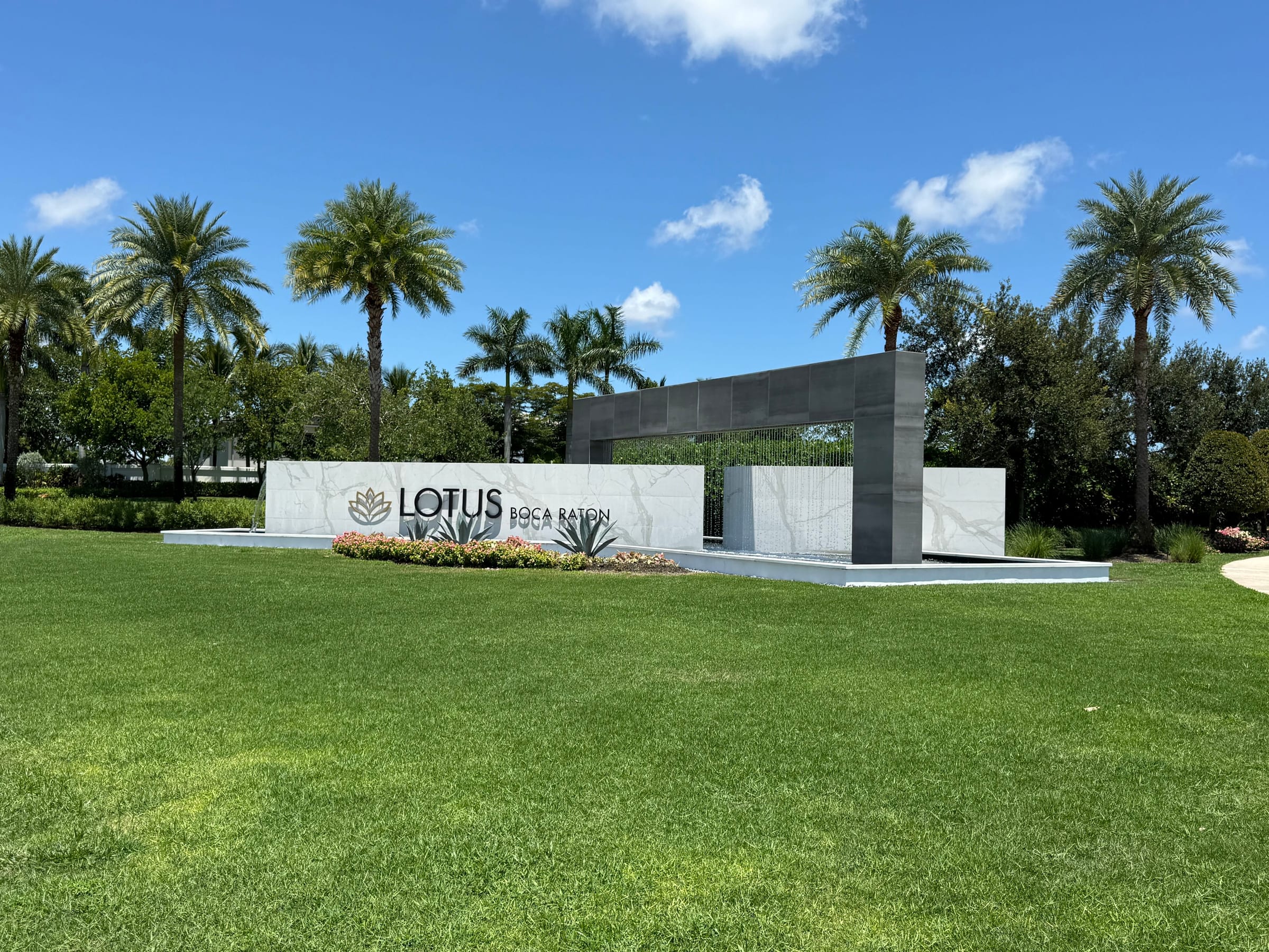 The Lotus Boca Raton entrance monument and water feature at the community gate on Lyons Road